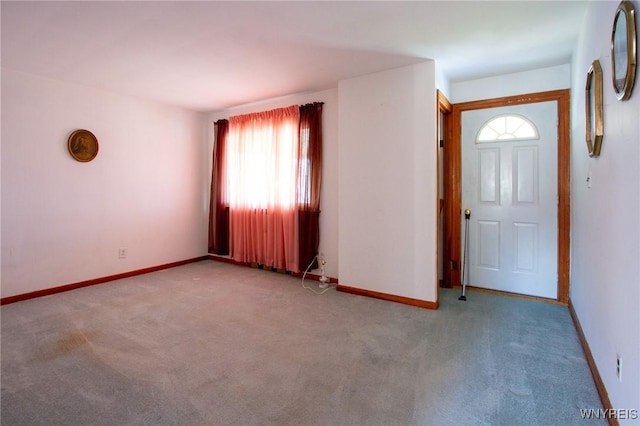 carpeted entrance foyer with baseboards