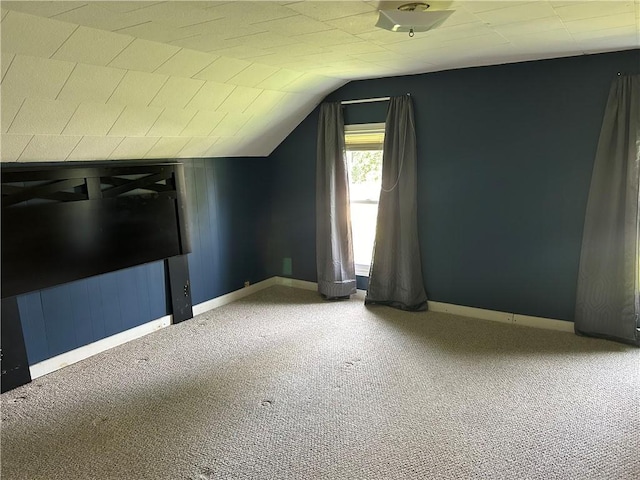 additional living space featuring vaulted ceiling, carpet floors, and baseboards