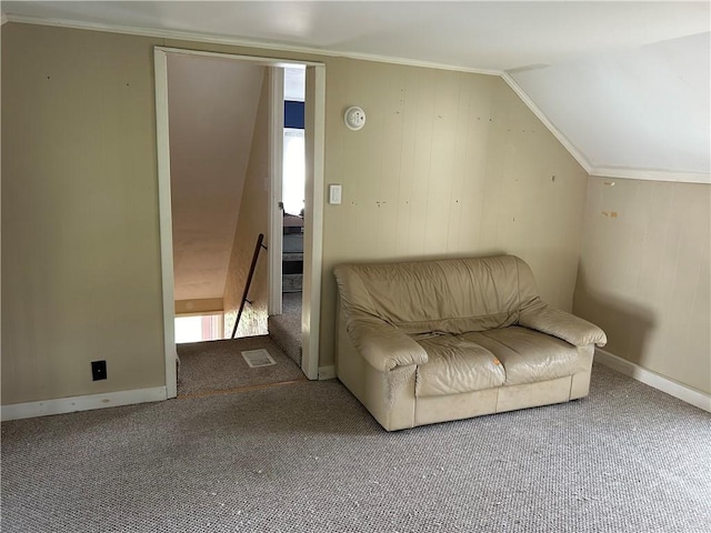 unfurnished room featuring carpet, vaulted ceiling, and crown molding