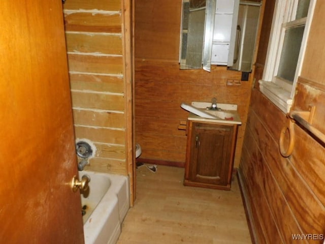 bathroom featuring wood walls and wood finished floors