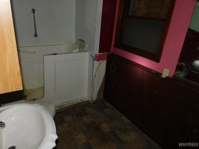 full bathroom with a tub and a sink