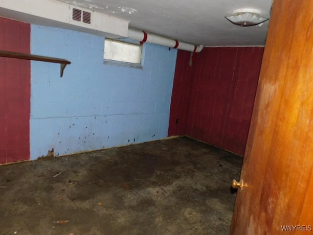 basement with visible vents and concrete block wall