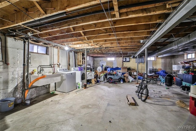 below grade area featuring a sink and separate washer and dryer