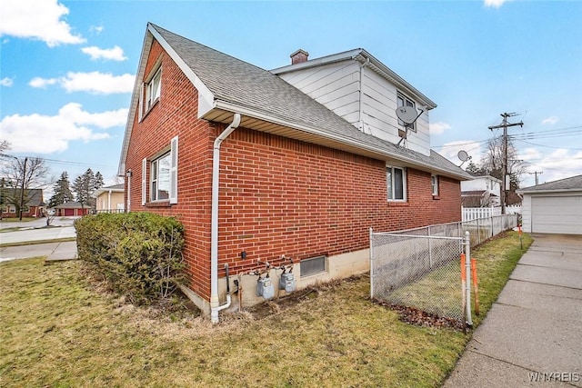 view of side of property with brick siding, a shingled roof, fence, a yard, and a chimney