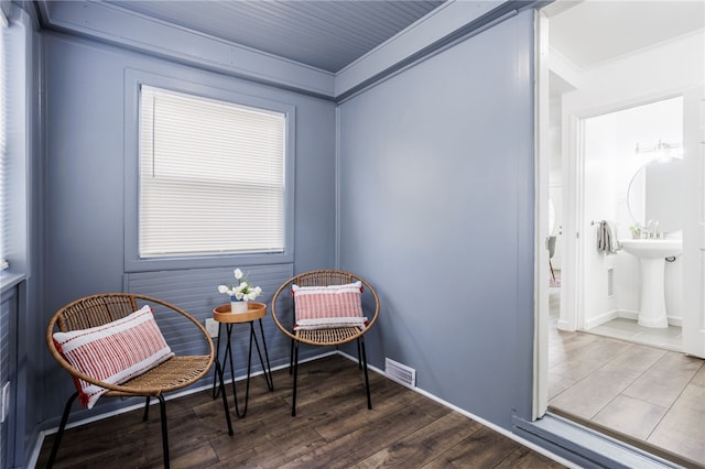 sitting room featuring visible vents and wood finished floors