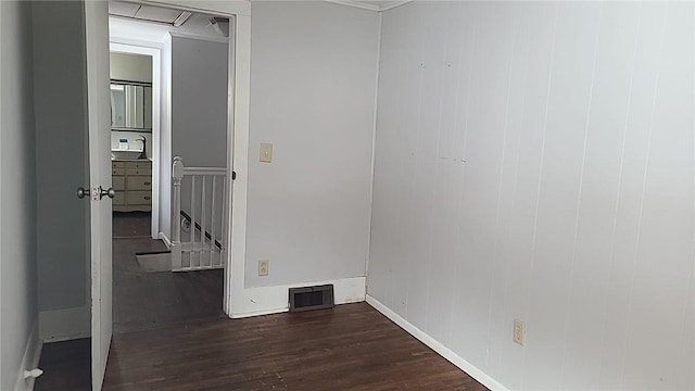 empty room featuring dark wood-style floors and visible vents