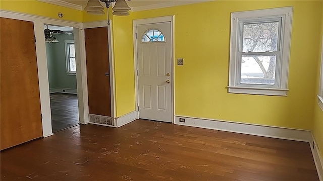 foyer entrance featuring ornamental molding and baseboards