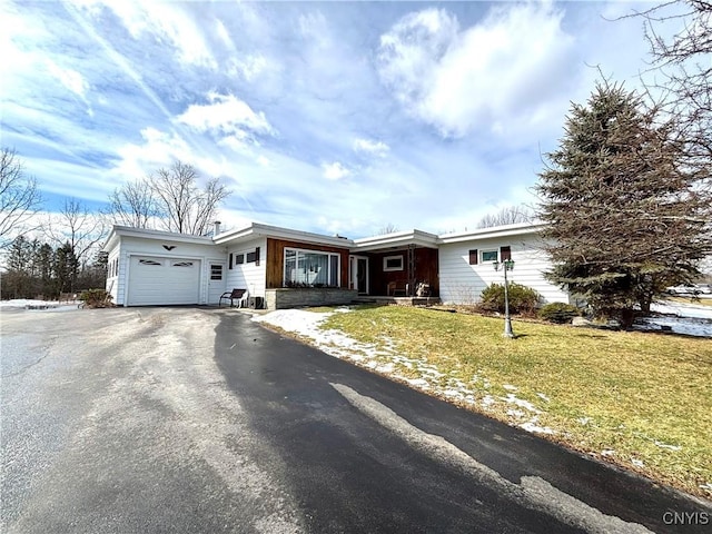 ranch-style house with a front yard, driveway, and an attached garage