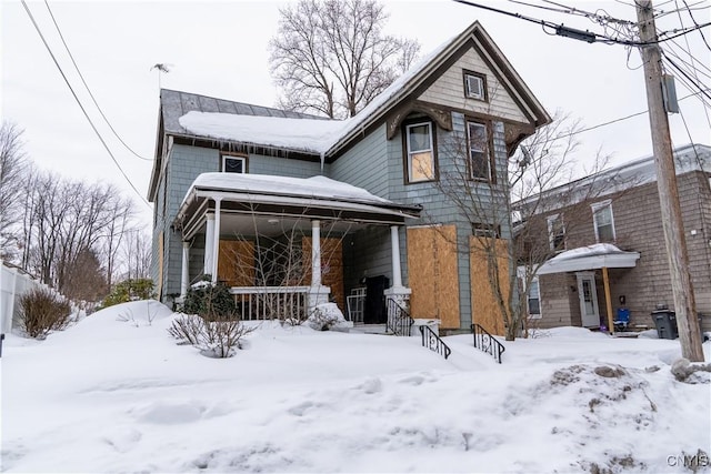 back of house featuring a garage and a porch