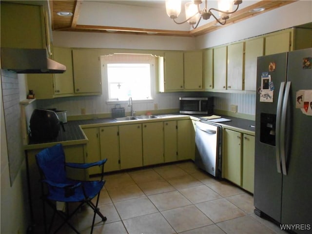 kitchen featuring a chandelier, cream cabinets, light tile patterned flooring, a sink, and appliances with stainless steel finishes