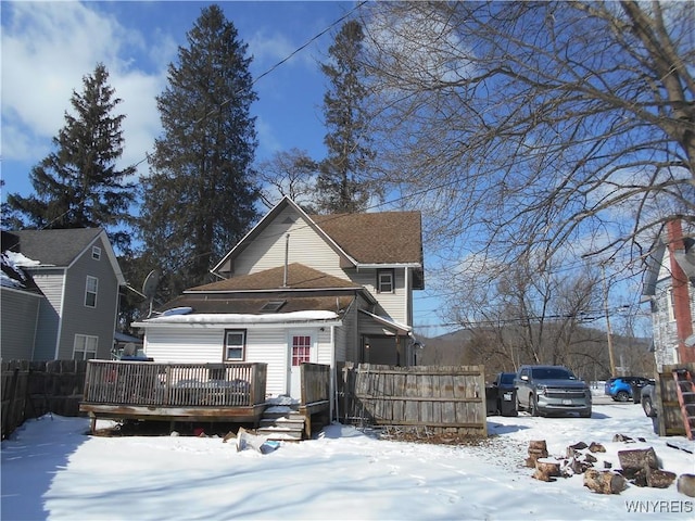 view of front facade featuring fence and a wooden deck