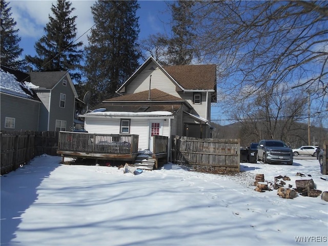 view of front of house featuring fence and a deck