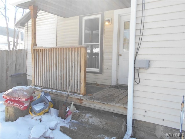 doorway to property featuring fence