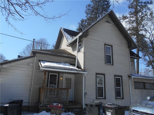 back of property with roof with shingles