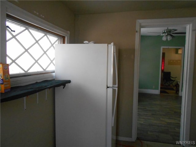 kitchen with a ceiling fan and freestanding refrigerator