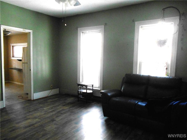 living area featuring baseboards and wood finished floors