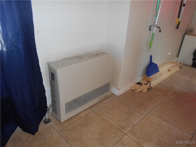 bathroom with tile patterned flooring and heating unit