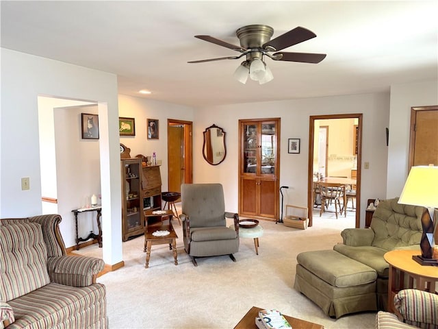 living area featuring recessed lighting, light colored carpet, ceiling fan, and baseboards