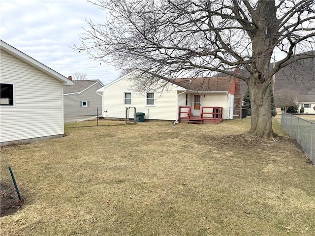 view of yard featuring fence and a deck