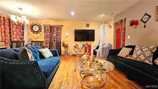 living area featuring a chandelier and wood finished floors