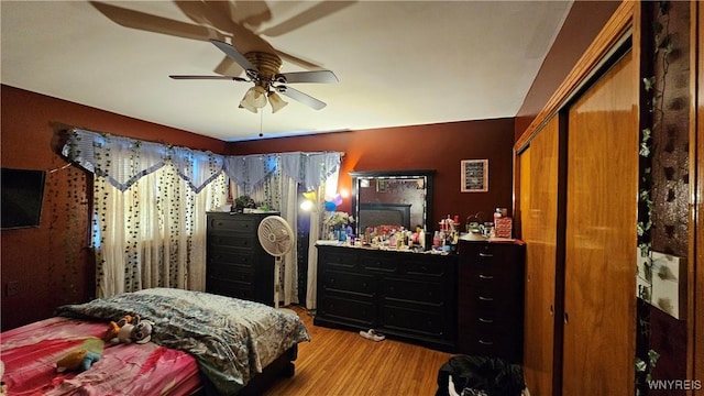 bedroom with wood finished floors and a ceiling fan