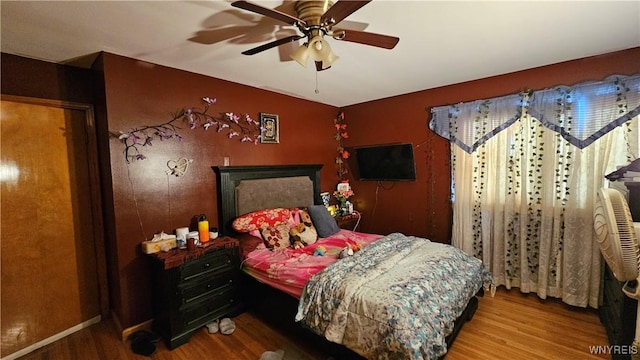 bedroom featuring ceiling fan and wood finished floors