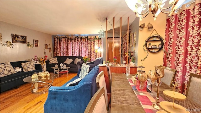 living room with wood finished floors and an inviting chandelier