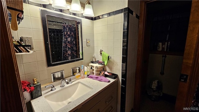 bathroom featuring backsplash, tile walls, and vanity