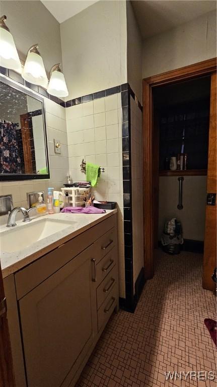 bathroom with tile walls and vanity