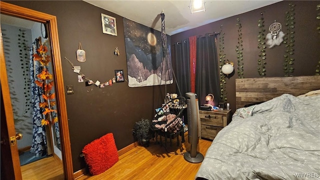 bedroom featuring baseboards and wood finished floors