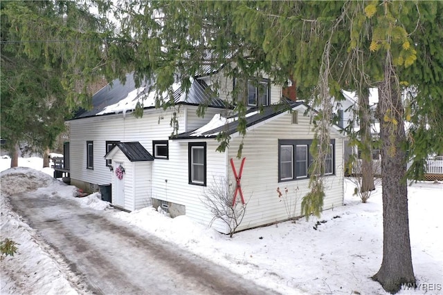 view of snowy exterior with metal roof