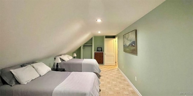 bedroom with lofted ceiling, baseboards, and recessed lighting