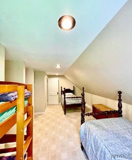 bedroom featuring baseboards and vaulted ceiling