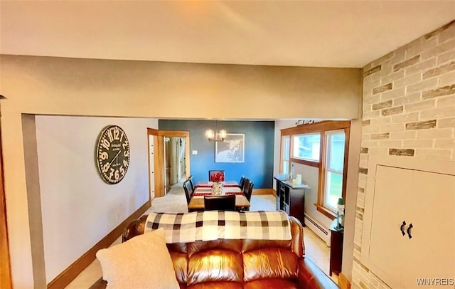 dining room featuring a chandelier, a baseboard radiator, and baseboards