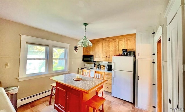 kitchen featuring white appliances, hanging light fixtures, baseboard heating, light countertops, and a kitchen bar