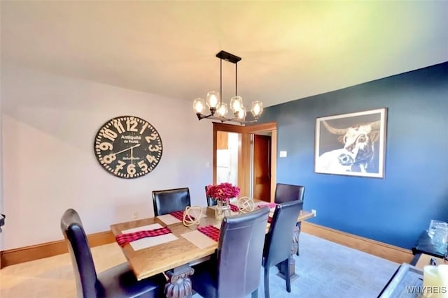 dining room with baseboards and a chandelier