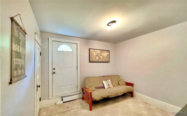 carpeted entrance foyer featuring a baseboard radiator and baseboards