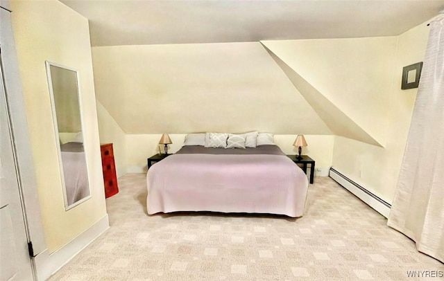 bedroom with carpet floors and a baseboard heating unit