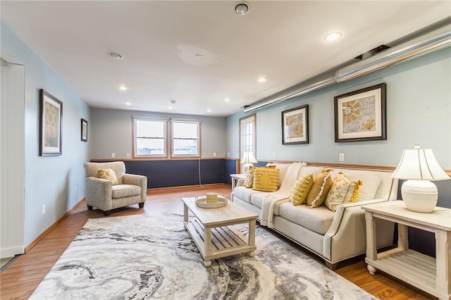 living room with baseboards, wood finished floors, and recessed lighting