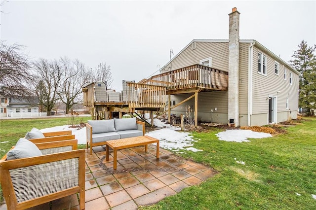 rear view of house featuring outdoor lounge area, stairs, a lawn, a wooden deck, and a patio area