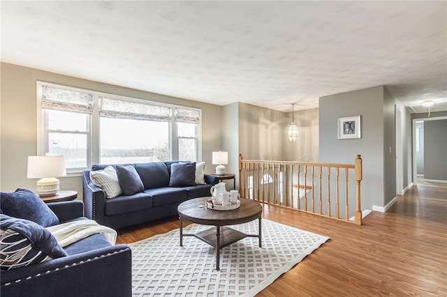 living area featuring baseboards and wood finished floors