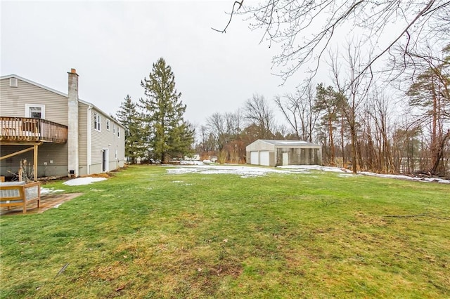 view of yard featuring an outbuilding, a deck, and a detached garage