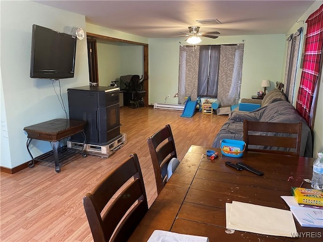 dining space featuring ceiling fan, wood finished floors, visible vents, and baseboards