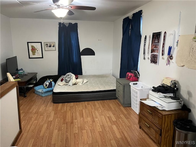 bedroom with ceiling fan and light wood-style flooring