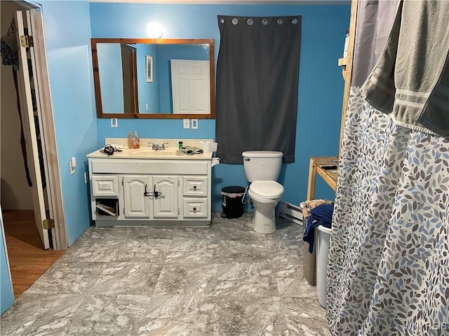 full bath with a baseboard radiator, vanity, and toilet