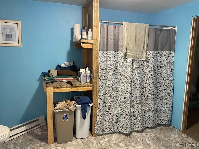 full bathroom featuring toilet, curtained shower, and a baseboard heating unit