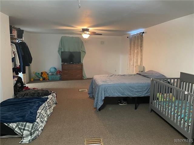 bedroom featuring carpet floors, ceiling fan, and visible vents