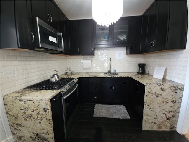 kitchen featuring appliances with stainless steel finishes and dark cabinetry