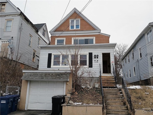 traditional-style house with entry steps and an attached garage