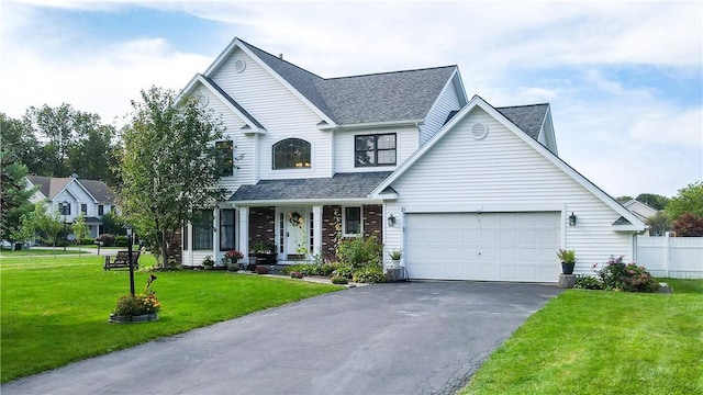 traditional-style house featuring aphalt driveway, roof with shingles, fence, a garage, and a front lawn